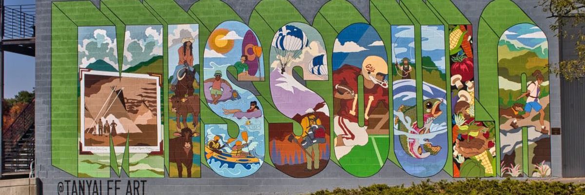 A mural with green letter and artwork showing different aspects of the city spelling out "Missoula".