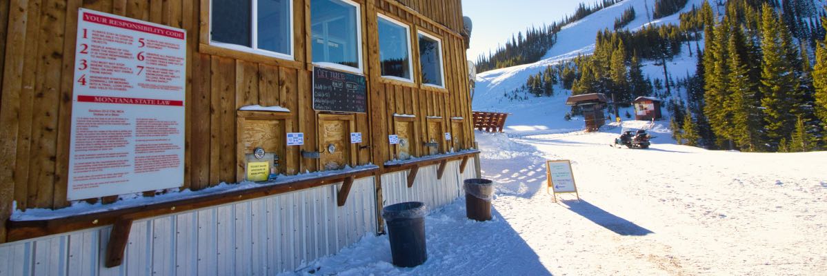 A ski slope with the lodge in the foreground.