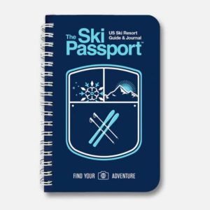 A blue spiral bound notebook that says "The Ski Passport" on it.