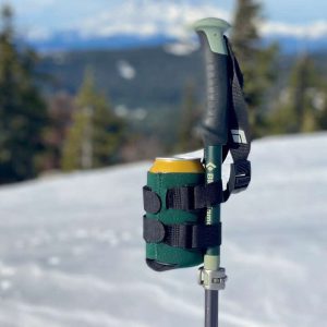 A ski pole with a green fabric can holder strapped to it.