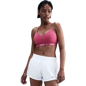 A woman wearing white shorts and a pink sports bra.