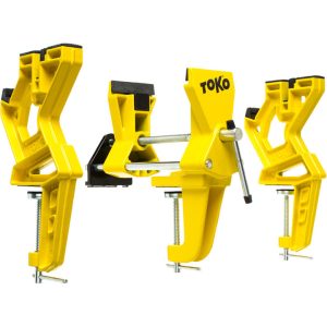 Three yellow vises with black pads to hold skis.