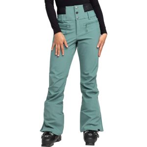 A woman wearing teal snow ski pants and black ski boots.