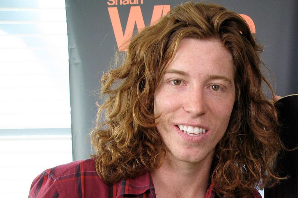 A photo of Shaun White with long red hair and freckles.